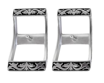 May include: Two silver-toned metal watch band buckles with a black floral design.