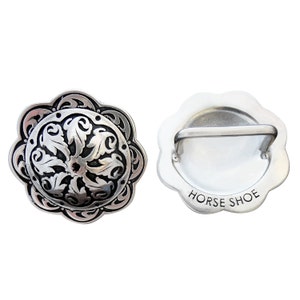 May include: Silver-toned metal horse shoe buckle with a decorative floral design on one side and the words "HORSE SHOE" on the other side.