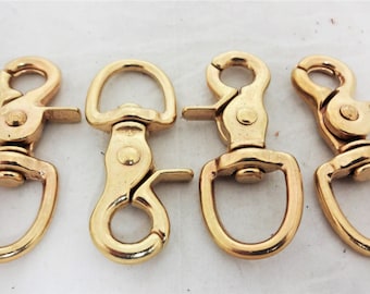 May include: Four gold-toned metal swivel snap hooks. Each hook has a D-ring on one end and a spring-loaded clasp on the other.