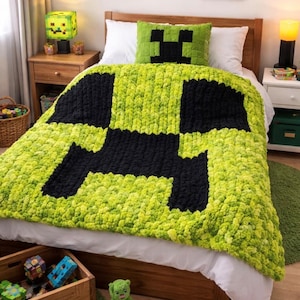 May include: A bed with a green and black Creeper-themed blanket and pillow. The blanket is a chunky knit design. The room also features framed pixel art, a Creeper lamp, and wooden furniture, creating a playful, themed bedroom.