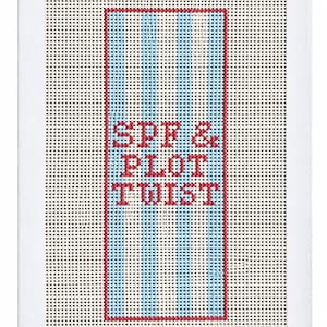 May include: A rectangular needlepoint canvas featuring a central design of vertical light blue and white stripes bordered by a red rectangular frame. The text SPF & PLOT TWIST is stitched in red block letters in the center of the striped area.