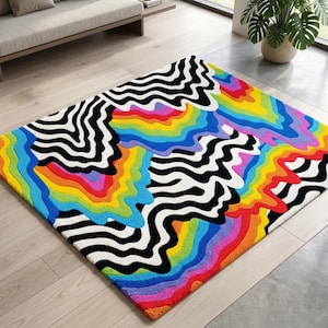 May include: A colorful area rug with a vibrant design. The rug features a pattern of black and white zebra stripes interspersed with rainbow-colored, wavy lines. The rug is rectangular and sits on a light-colored wooden floor.