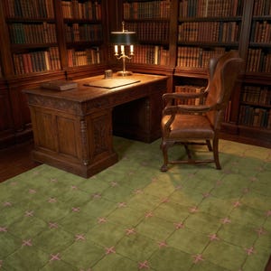 May include: A green area rug featuring a grid pattern with small pink cross-stitch accents at each intersection, placed in a room with a dark wood desk, a matching leather wingback chair, and floor-to-ceiling wooden bookshelves.