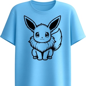 May include: Light blue t-shirt featuring a black and white cartoon illustration of a creature with large ears and a fluffy tail. The graphic is centered on the front of the shirt. The shirt has a crew neck and short sleeves.