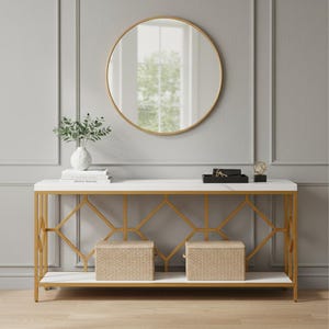 May include: A modern console table with a white marble top and gold geometric frame. A round gold-framed mirror hangs above the table. Two woven baskets sit on the lower shelf. A white vase with greenery and decorative items complete the decor.