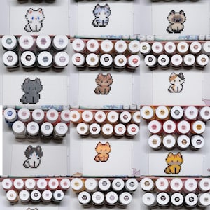 May include: A collection of colorful paint bottles arranged above pixelated cat designs. The cats are in various colors and patterns, created with small, square beads on a white pegboard. The paint bottles have white lids with color-coded labels.