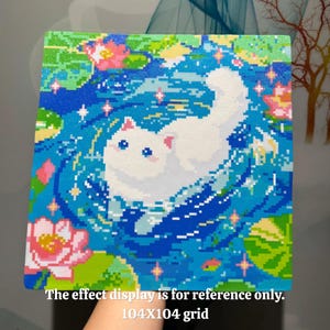 May include: A square pixel art illustration featuring a white cat swimming in a blue pond with pink lotus flowers and green lily pads. The image includes sparkling star accents and the text: The effect display is for reference only. 104X104 grid.