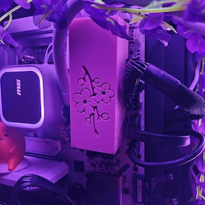 May include: A set of three ceramic mugs with a speckled, matte finish. The mugs are in shades of cream, light gray, and dark gray. Each mug has a simple, minimalist design and a rounded handle.