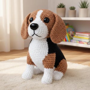 May include: A crocheted beagle dog in brown, white, and black. The dog has large, floppy ears, a black nose, and big, round eyes. It is sitting on a cream-coloured rug. The dog is a handmade item.