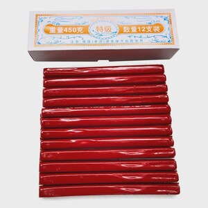 May include: A box of 12 red sealing wax sticks, each with a glossy finish, are displayed below a white box with Chinese text. The box indicates a weight of 450 grams.