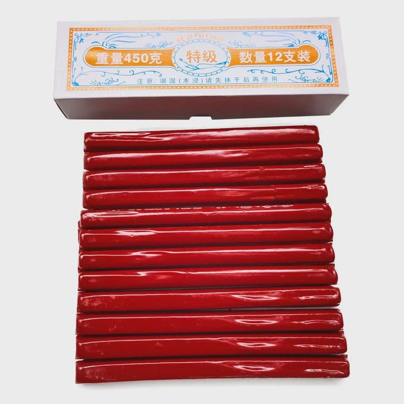 May include: A box of 12 red sealing wax sticks, each with a glossy finish, are displayed below a white box with Chinese text. The box indicates a weight of 450 grams.
