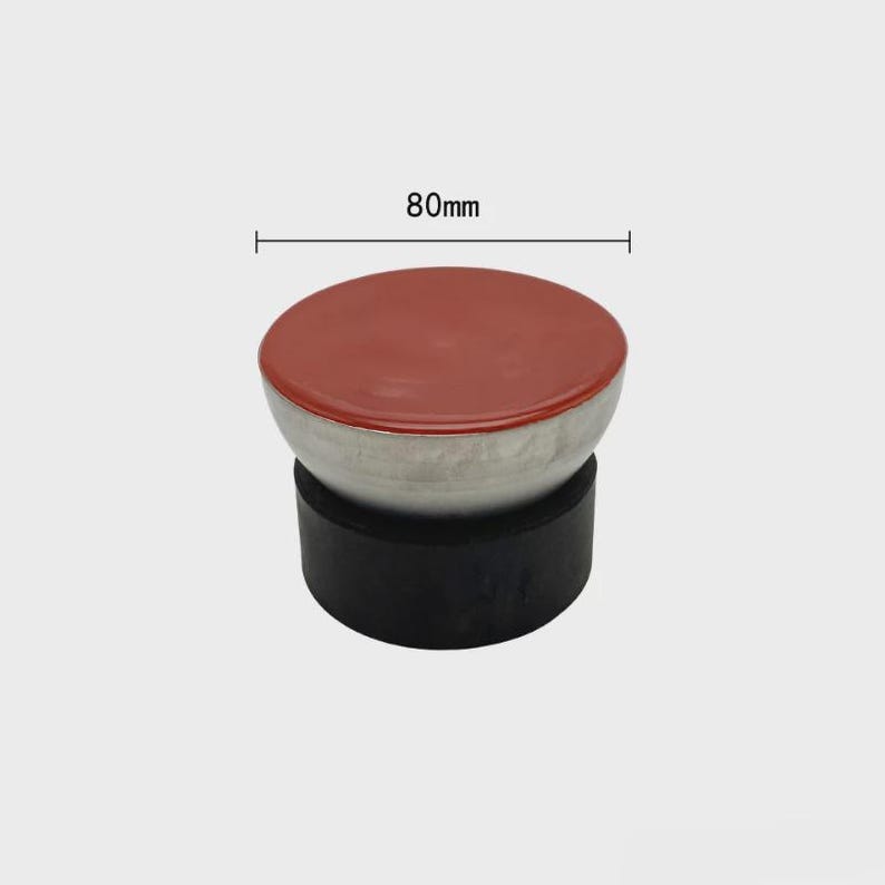 May include: A three-part object with a red top, a silver-colored middle section, and a black base. The top is 80mm in diameter. The object appears to be a stopper or a decorative element.