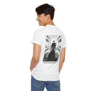 May include: White t-shirt with a black and white graphic on the back. The graphic features a stylized figure with a flame-like head and the text: "THE ONLY WAY TO TRULY ESCAPE THE BOREDOM IS FOR YOU TO CONSTANTLY BE EXPLORING."