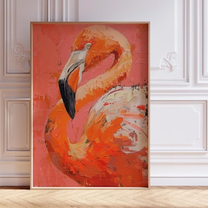 May include: An orange and white flamingo painting with a black beak, set against a pink background. The artwork is in a wooden frame and leans against a white wall with decorative molding. The painting's style is impressionistic.