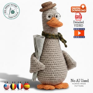 May include: A crocheted goose wearing a brown hat, round glasses, and a green scarf, holding a newspaper. The goose has an orange beak and feet. The image includes text that says "Real Crochet Pattern" and "No AI Used, Human-Made Pattern."