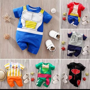 May include: A collection of baby rompers in various designs, including blue with white and yellow accents, red with a torso print, gray with black accents, orange and white stripes, green with a pink sash, and black with red clouds. Each outfit is paired with white baby shoes.