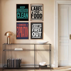 May include: Four framed kitchen-themed wall art prints with text: "KEEP REFRIGERATOR CLEAN", "LABEL YOUR FOOD", "CHECK EXPIRATION", and "FIRST IN FIRST OUT". The prints are in black, white, teal, red, and navy blue.