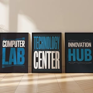 May include: Three framed posters with black frames and white and blue text. The posters read "COMPUTER LAB", "TECHNOLOGY CENTER", and "INNOVATION HUB". The posters are leaning against a white wall on a wooden floor.