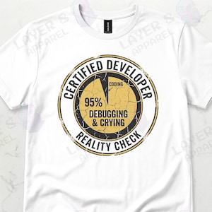 May include: White t-shirt with a distressed graphic. The graphic is a pie chart with the words "CERTIFIED DEVELOPER" around the edge. The chart shows "95% Debugging & Crying" and "Coding". The text "REALITY CHECK" is also included.