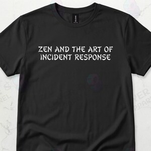 May include: Black t-shirt with the white text "ZEN AND THE ART OF INCIDENT RESPONSE". The shirt is made of a soft material and is suitable for casual wear. A smartphone and headphones are visible in the background.