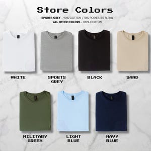 May include: A selection of folded t-shirts in colours such as white, grey, black, sand, military green, light blue, and navy blue. The image includes the text "Store Colors" and fabric composition details.