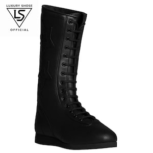 May include: Black leather knee-high boot with star accents and a lace-up closure. The boot features a flat sole and a pointed toe. The text "LUXURY SHOSE OFFICIAL" is in the upper left corner.