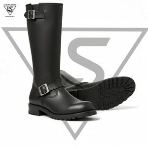 May include: Black leather knee-high boots with silver buckles. The boots have a round toe and a lug sole. The boots are displayed on a white background. The boots are a classic style.