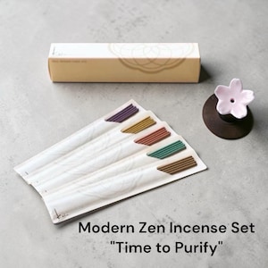 May include: A Modern Zen Incense Set with the text "Time to Purify." The set includes incense sticks with colored tips, a decorative box, and a small pink flower-shaped incense holder.
