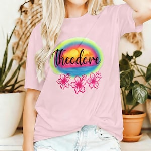 Maglietta personalizzata con nome e motivo tramonto tropicale, top tie-dye sfumato con fiori di ibisco oceanici, abbigliamento casual personalizzato con scritta in corsivo, capo ricordo