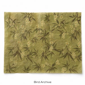 May include: A rectangular sheet of textured, olive green paper featuring a repeating pattern of dark green bamboo leaves and small, pale yellow blossoms. The surface has a crinkled, organic appearance with visible fibers throughout the material.