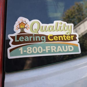 May include: A rectangular sticker with rounded corners featuring a treehouse graphic and the text Quality Learing Center in green and brown. Below this, a light blue banner displays the phone number 1-800-FRAUD in bold white capital letters.