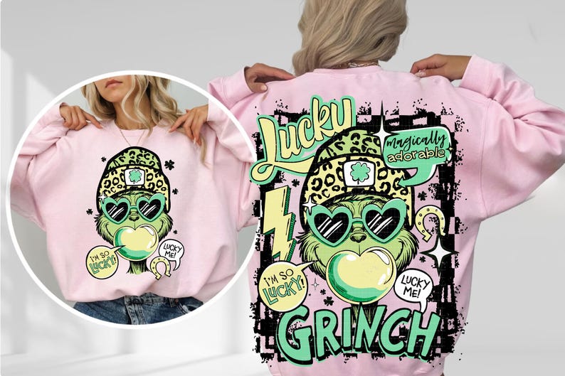 K&ouml;nnte beinhalten: Ein hellrosa Sweatshirt mit einem Cartoon-Grinch-Design. Der Grinch tr&auml;gt herzf&ouml;rmige Sonnenbrillen und einen Leopardenhut. Das Design enth&auml;lt die W&ouml;rter "Lucky" und "Grinch" in Gr&uuml;n und Schwarz, mit Textblasen mit der Aufschrift "I'm so lucky!" und "Lucky me!"