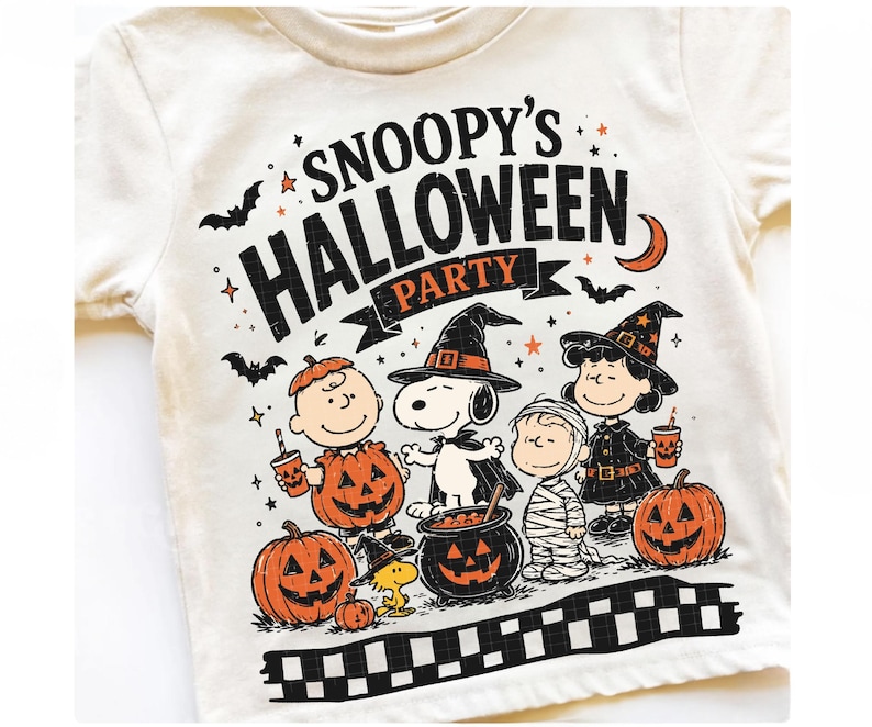 May include: A cream-colored t-shirt featuring a graphic print with the text SNOOPY'S HALLOWEEN PARTY. The design includes Snoopy, Charlie Brown, Lucy, and Woodstock in costumes, surrounded by pumpkins, bats, a crescent moon, and stars.