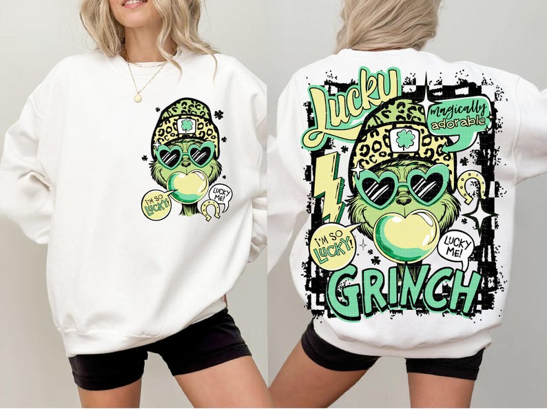 K&ouml;nnte beinhalten: Wei&szlig;es Sweatshirt mit einem Grinch-&auml;hnlichen Charakter, der eine herzf&ouml;rmige Sonnenbrille, einen Leopardenhut und eine Kaugummiblase tr&auml;gt. Der Text enth&auml;lt "I'm so lucky" und "Lucky Me!". Auf der R&uuml;ckseite steht "Lucky" und "Grinch".