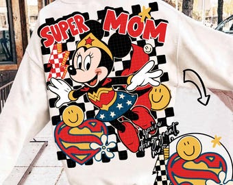 May include: A white long-sleeve sweatshirt featuring a large graphic on the back. The design includes the text "SUPER MOM" in red, a cartoon mouse dressed as a superhero, a black and white checkered pattern, yellow smiley faces, and a red heart with a yellow "S" logo. The text "you're doing great" is also visible.