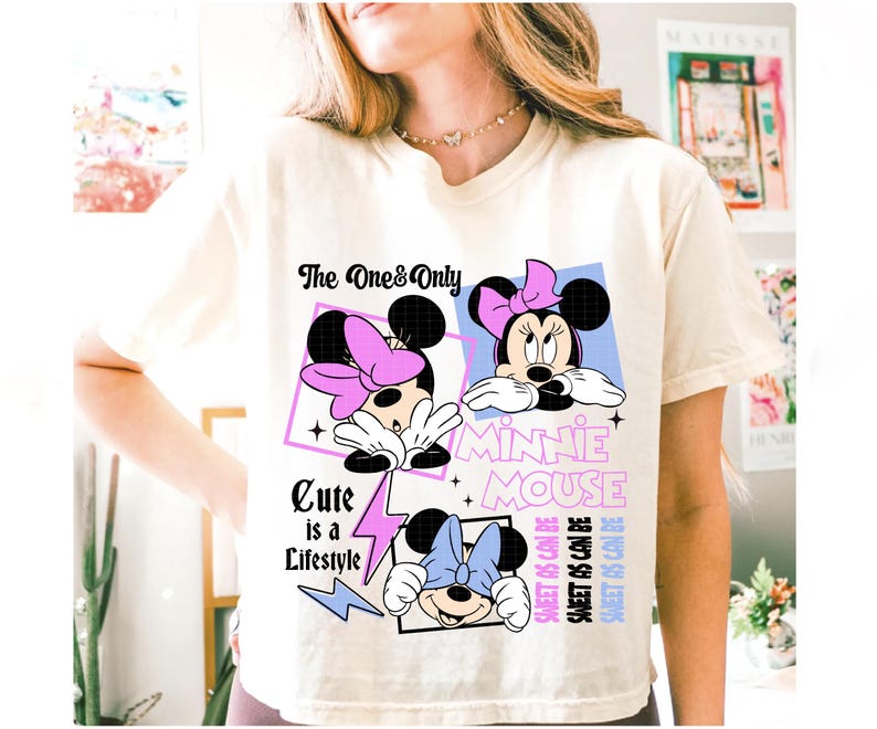 May include: Cream-colored t-shirt featuring a Minnie Mouse graphic. The design includes three images of Minnie Mouse with different colored bows, the text "The One & Only", "Cute is a Lifestyle", and "Sweet as can be".