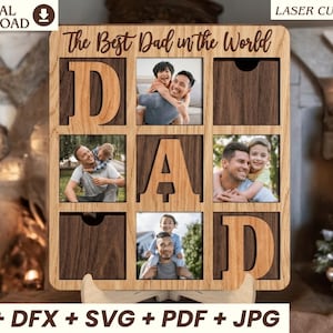 May include: A square wooden photo frame with a grid design featuring the text The Best Dad in the World at the top. The frame includes cutouts for three photographs and large wooden letters spelling DAD, with dark wood panels and light wood accents.
