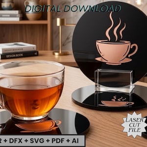 May include: A clear glass teacup filled with tea sits on a black coaster with a copper-colored coffee cup design. A black acrylic coffee cup design with steam rising from the cup is displayed on a clear stand. Text on the image reads "DIGITAL DOWNLOAD" and "LASER CUT FILE".