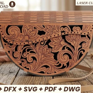 May include: A semi-circular wooden handbag featuring an intricate laser-cut floral pattern with swirling vines and petals over a solid black background. The bag has a hinged top flap, light tan leather-like straps, and metal hardware connectors.
