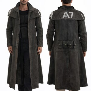May include: A long, dark gray coat with a wide collar and a flared skirt. The coat features a weathered appearance, with white accents on the shoulders and the letters "A7" on the back. It has multiple pockets and a button-up front.
