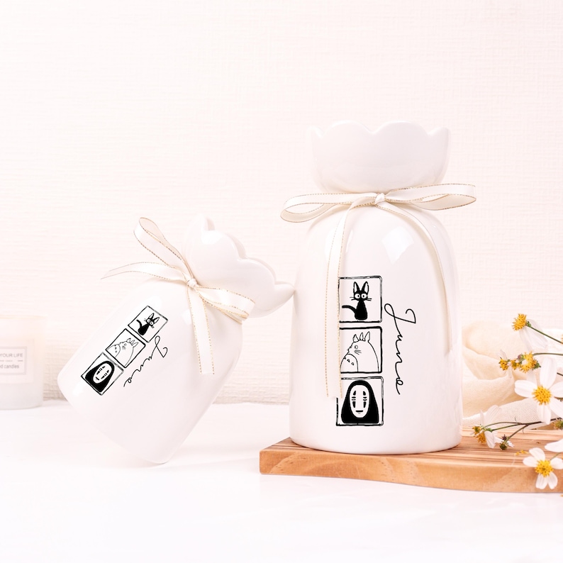 May include: A set of three ceramic mugs with a speckled, matte finish. The mugs are in shades of cream, light gray, and dark gray. Each mug has a simple, minimalist design, perfect for coffee or tea.