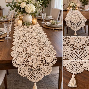May include: A cream-coloured crochet table runner featuring an intricate floral pattern with scalloped edges and a decorative tassel at the end. The runner is crafted with a detailed openwork design, showcasing repeating flower motifs and delicate lace-like stitching.