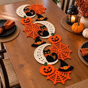 Może przedstawiać: Szydełkowy bieżnik na stół w stylu Halloween z powtarzającymi się motywami kremowych półksiężyców z czarnymi kotami, jaskrawopomarańczowymi pajęczynami, pomarańczowymi dyniami oraz czarnymi kapeluszami czarownic z żółtymi klamrami.