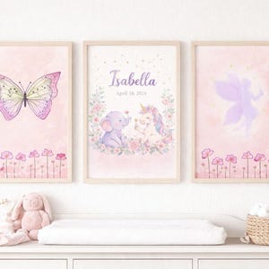 May include: Three framed watercolor art prints with a pink and purple theme. The prints feature a butterfly, a unicorn and elephant with the name "Isabella" and date, and a fairy. Floral accents and a pink background.