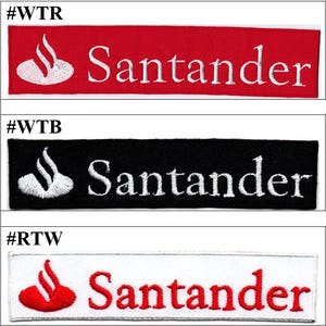 Pode incluir: Três emblemas retangulares bordados com o logótipo Santander. O primeiro é vermelho com bordado branco, o segundo é preto com bordado branco e o terceiro é branco com bordado vermelho. Cada emblema apresenta o texto Santander.