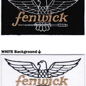 May include: Two rectangular embroidered patches featuring a stylized eagle with outstretched wings. One patch has a black background with white embroidery, the other a white background with black embroidery. Both feature the text fenwick in gold.