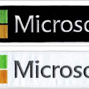 May include: Two rectangular embroidered patches featuring the Microsoft logo. The top patch has a black background with white text and a four-coloured square icon. The bottom patch has a white background with dark grey text and the same icon.