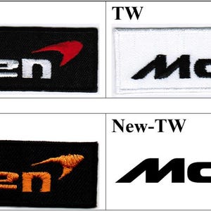 May include: Four rectangular embroidered patches featuring the McLaren logo. The top left patch is black with white text and a red speedmark. The top right is white with black text and a red speedmark. The bottom left is black with orange text and an orange speedmark. The bottom right is white with black text and an orange speedmark.
