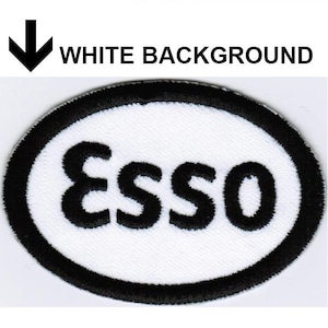 May include: Three oval-shaped embroidered patches featuring the text Esso. The first patch has a black center with white text and a white border. The second has a white center with black text and a black border. The third has a white center with red text and a blue border.