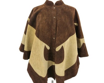 May include: A brown suede poncho with a high collar and button closure. The poncho features a unique design with alternating panels of dark and light brown suede. The garment is displayed on a white mannequin.